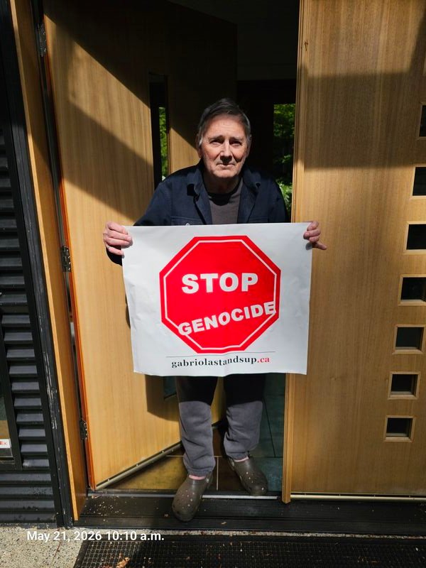 Bill with his Stop Genocide sign on Barrett Road, Gabriola