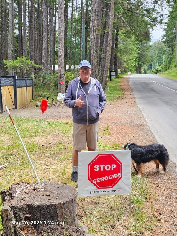 Dale with his Stop Genocide sign on North Road, Gabriola