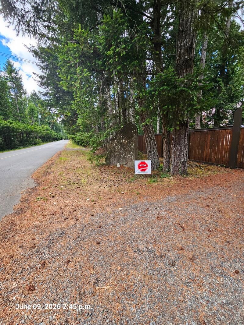 Dave's Stop Genocide sign on Malaspina Drive, Gabriola