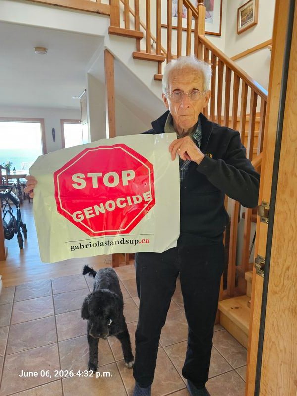 Keith and Eva with their Stop Genocide sign on Eva Road, Gabriola