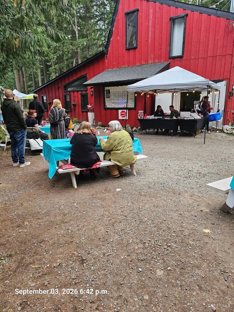 Gabriola Stands Up STOP GENOCIDE sign outreach at the Gabriola Theatre Festival