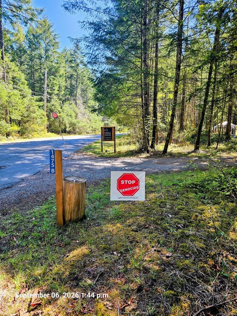 Stop Genocide sign at the entrance to the Gabriola Theatre Centre - sign #116