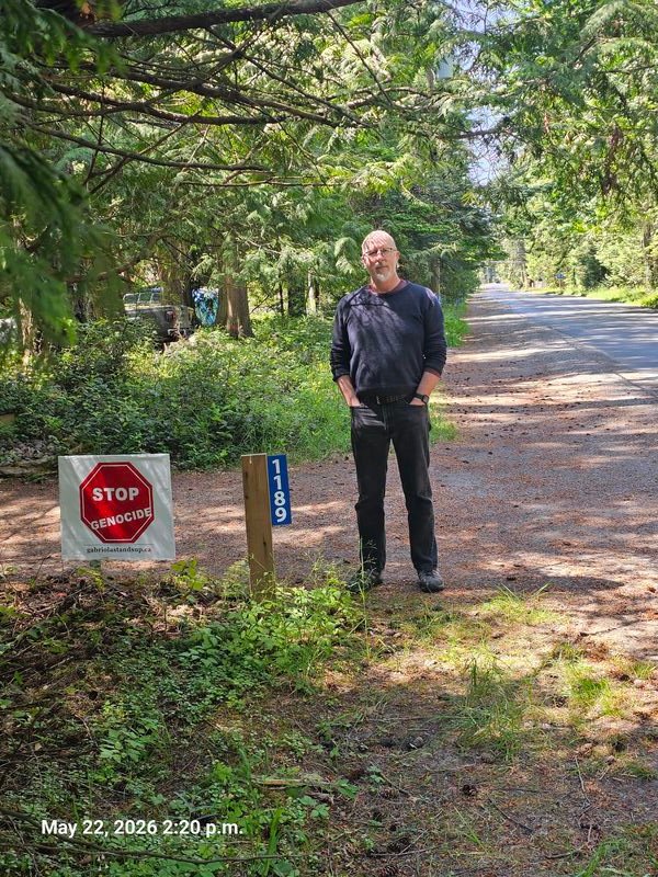 Tim with his Stop Genocide sign on North Road, Gabriola